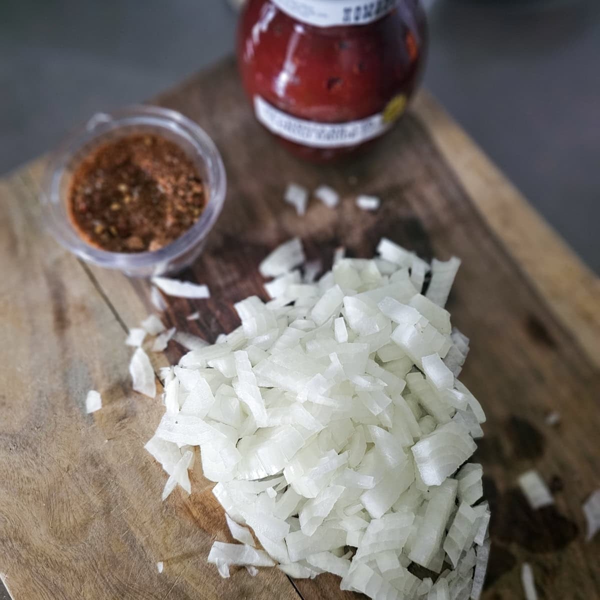 Diced onion on a cutting board.