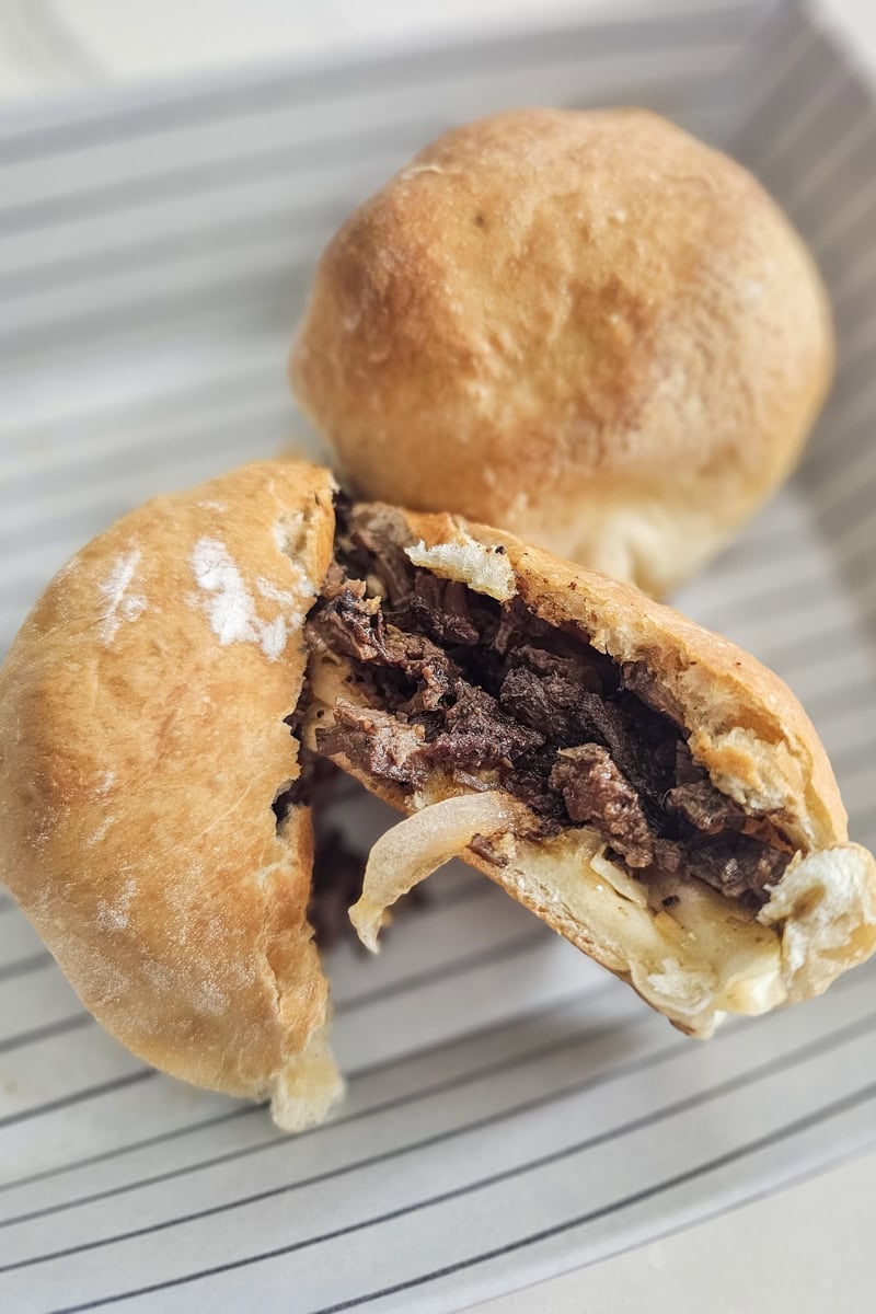 BBQ brisket kolaches on a serving tray.