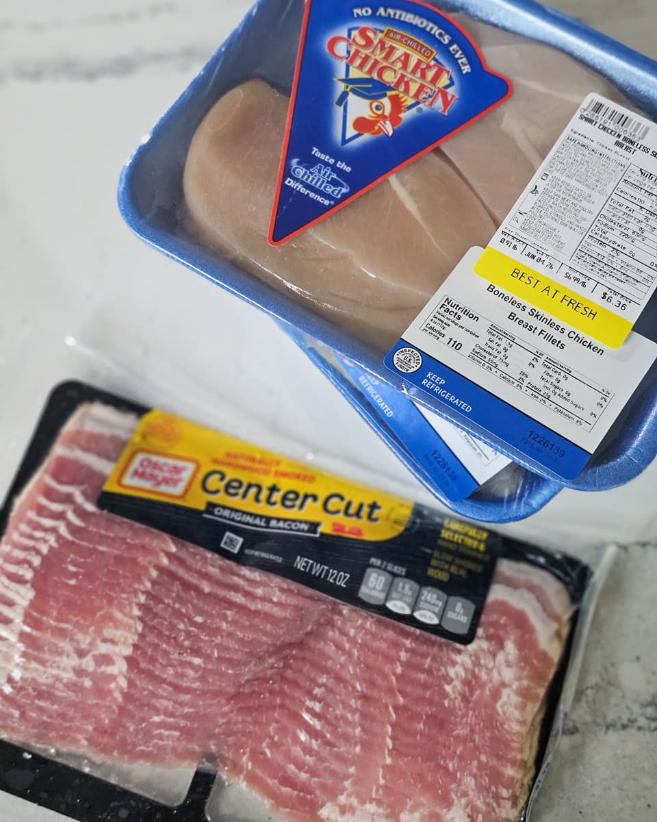 Packages of chicken breasts and bacon.