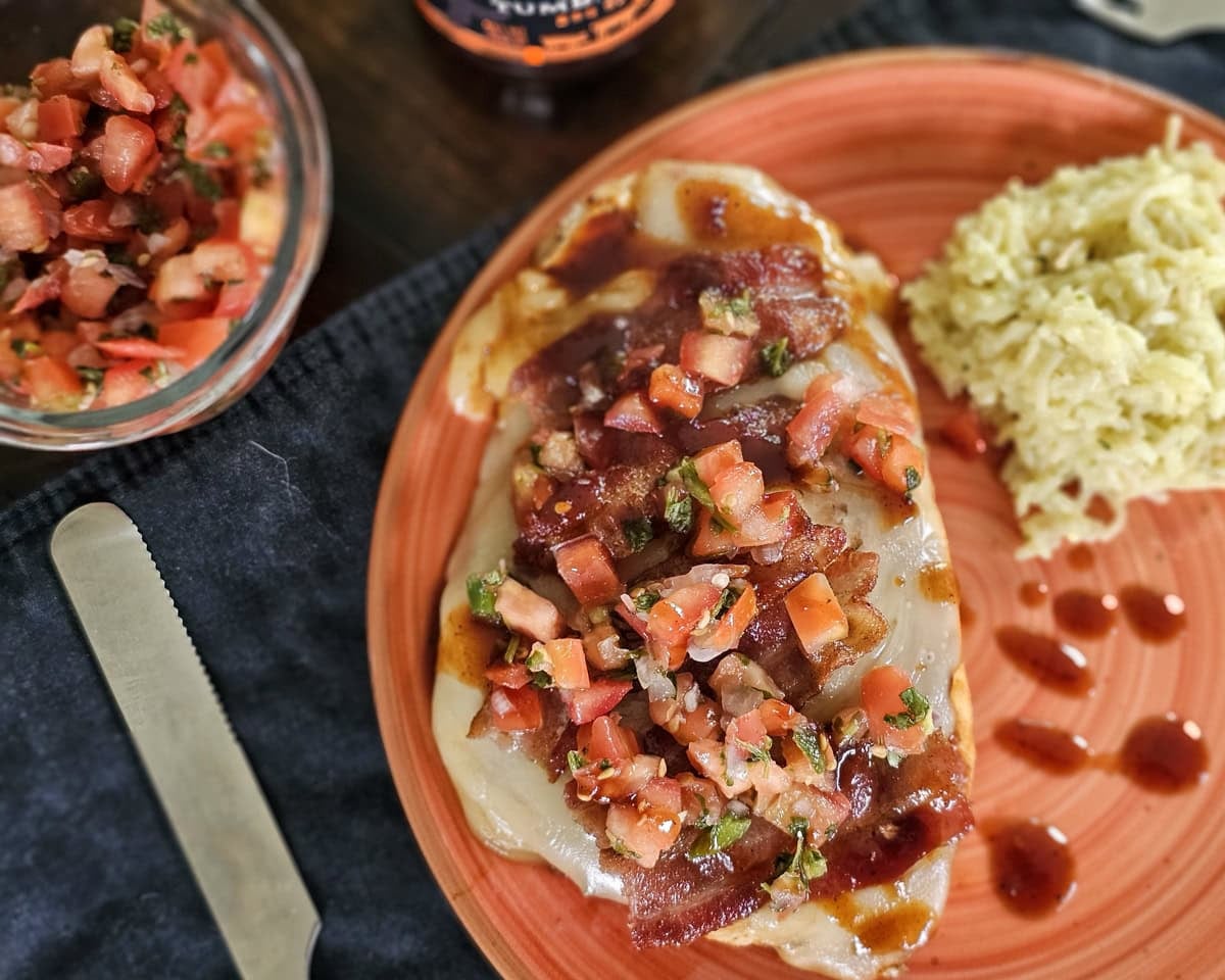 Orange plate with Blackstone Monterey chicken, served with rice.