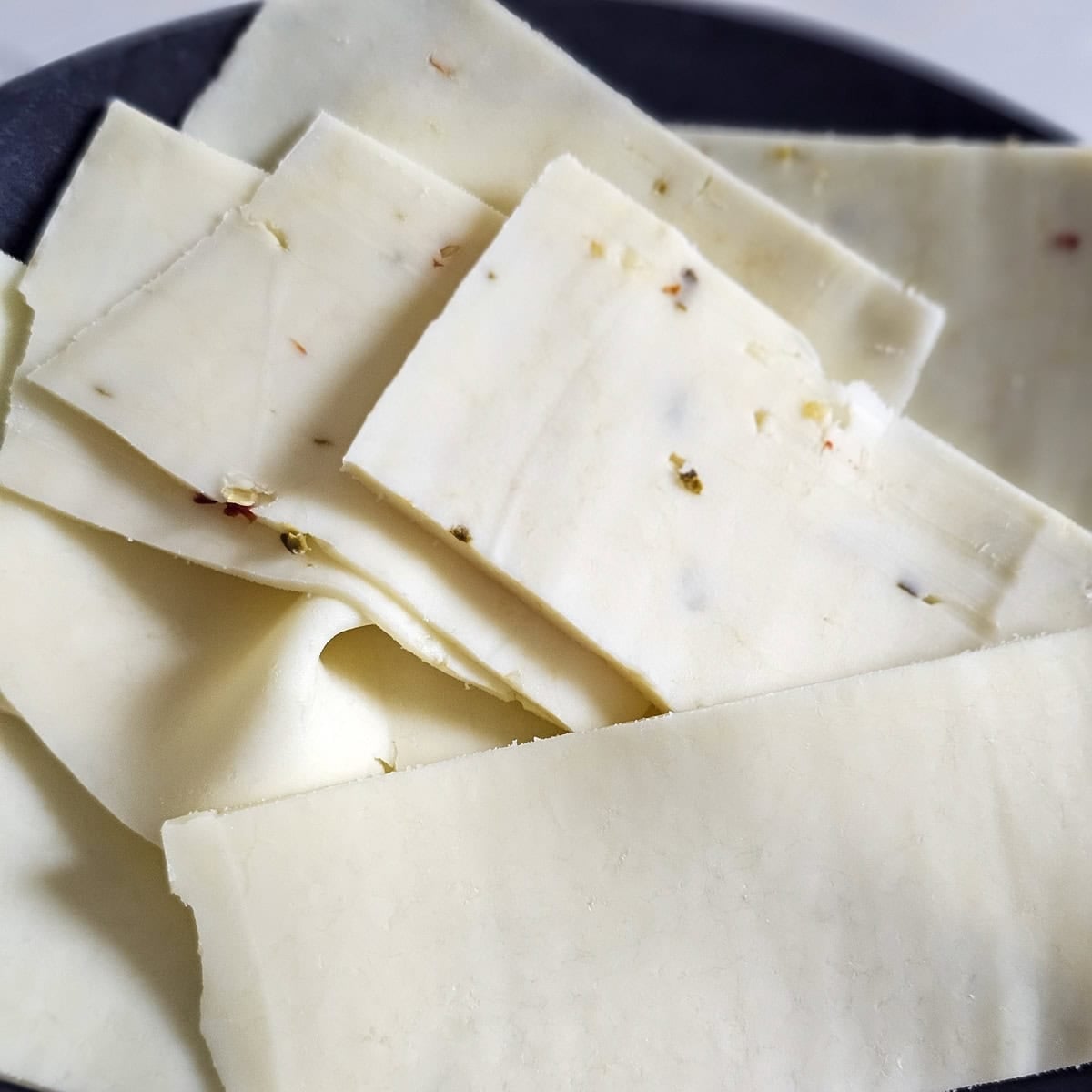 Plate with slices of Monterey jack and pepper jack cheese.