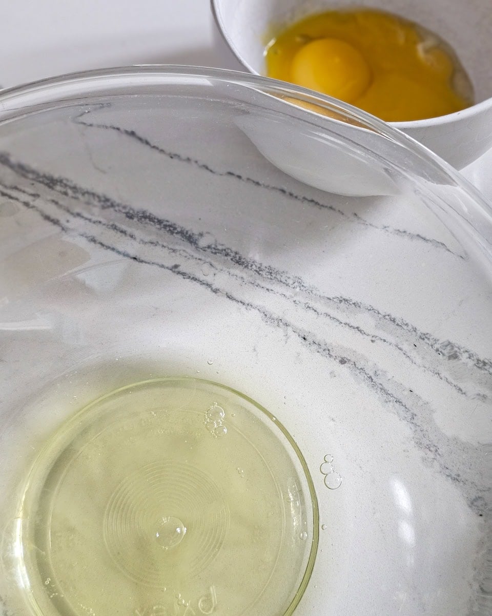 Egg white and yolks separated between 2 bowls.