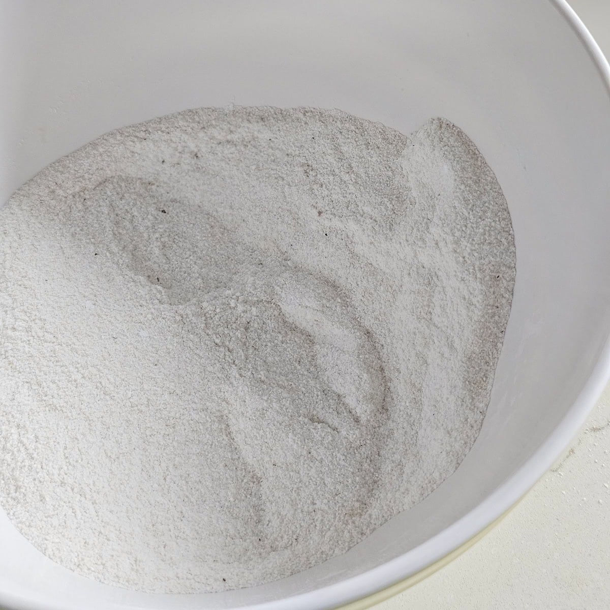 White cornmeal, salt, and baking powder in a bowl.