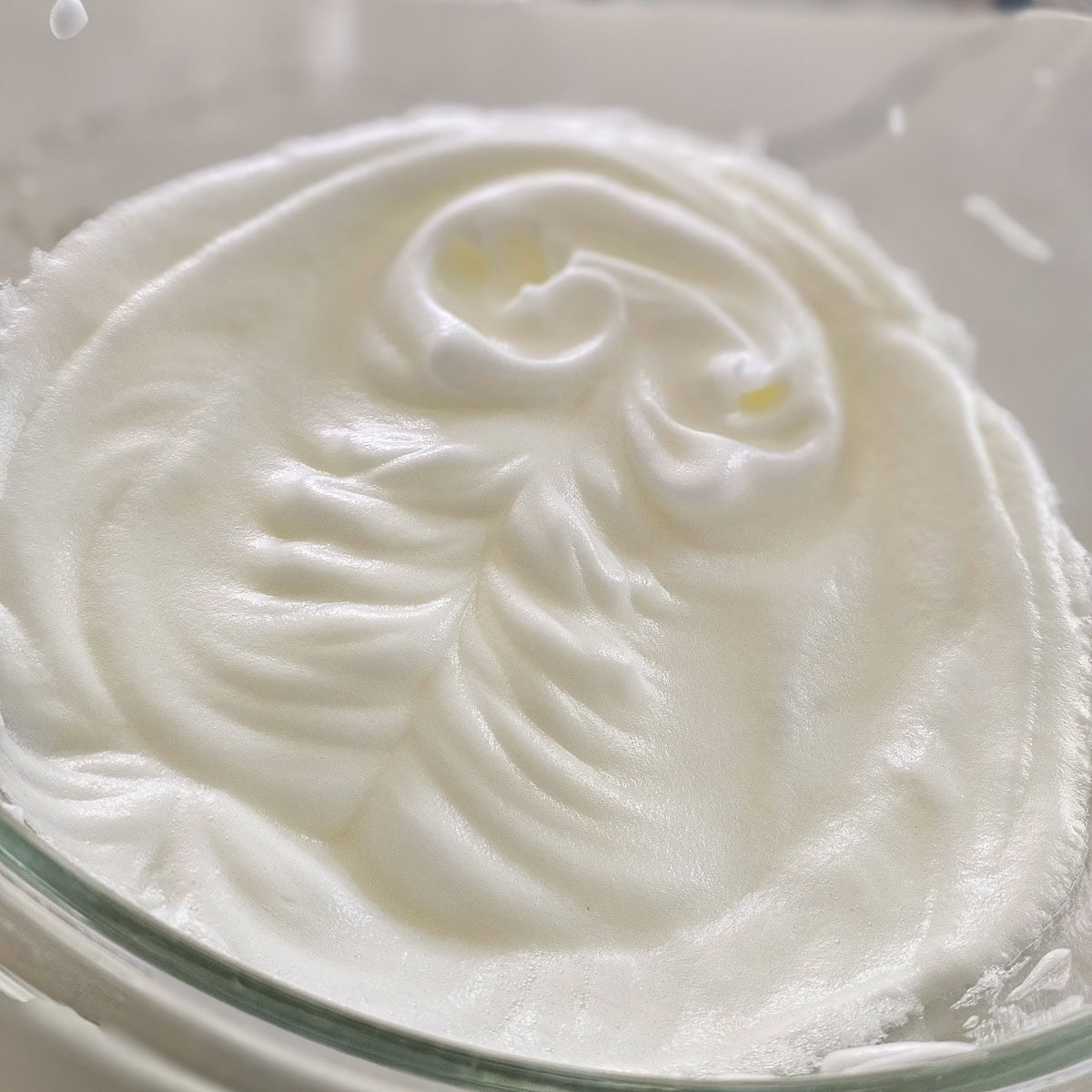 Whipped egg whites in a bowl.