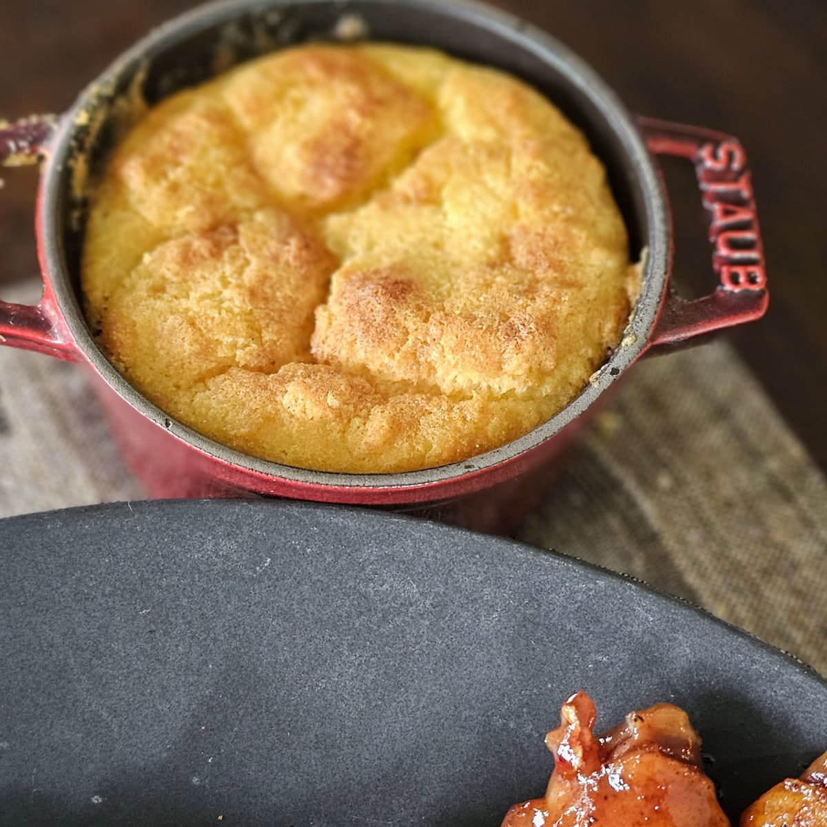 Red ramekin with homemade spoon bread.