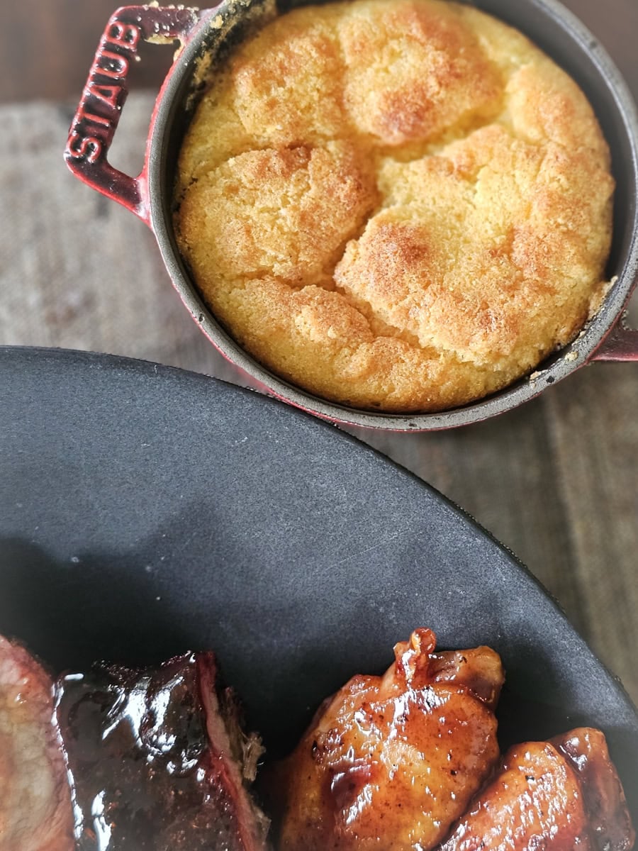 Southern Spoon Bread served with a plate of BBQ.